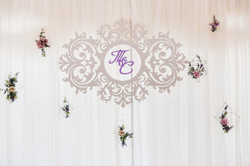 inscription with the initials of the newlyweds hang on tulle