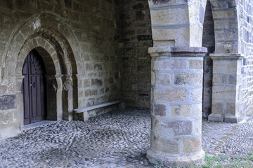 sight of the entry of the Romanesque collegiate church of San Salvador in Cantamuda in Palencia, Castile and León, Spain