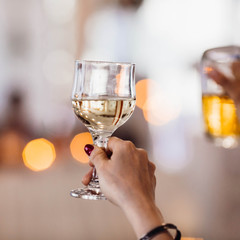 waman's hand holding a glass of alcoholic drink