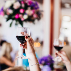 waman's hand holding a glass of alcoholic drink