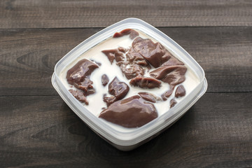 raw turkey liver in milk in plastic container