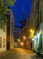 Night at medieval street in old Riga - capital city of Latvia and famous place of ancient and medieval architecture in Baltic region