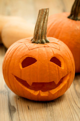 Smiling lantern pumpkin on a wooden background