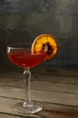 Wine in a glass with a citrus piece