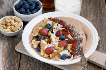 oatmeal with fresh fruit, nuts and chia for breakfast, top view