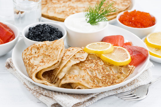 traditional Russian crepes with caviar and salted fish