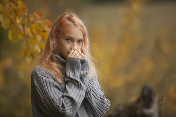 The little girl in the autumn forest