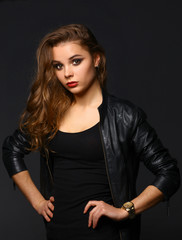 Portrait of beautiful brunette female wearing leather jacket