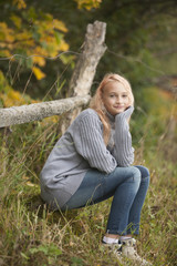 Obraz premium The little girl in the autumn forest