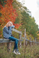 The little girl in the autumn forest