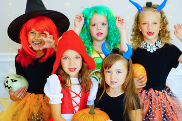 Happy group of children in costumes during Halloween party