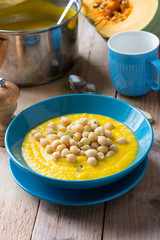 Spicy pumpkin cream soup with chickpeas and fresh thyme