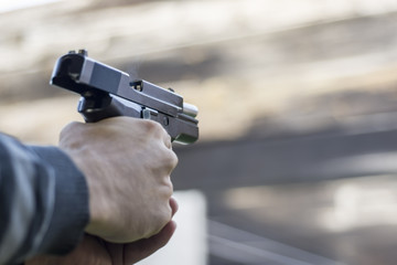 Gun Fire Street Assault. Shooting a Handgun and Smoke Coming out of Barrel.