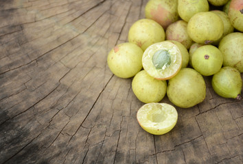 Indian gooseberry.Wood background with cracks.