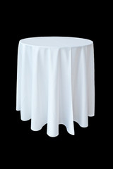 Banquet table with white tablecloth isolated on black