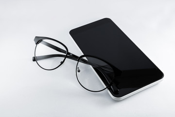 Glasses and smartphone on white background.