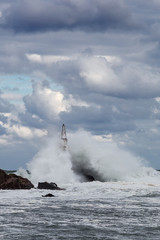 Big waves crashing into lighthouse