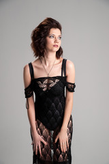 Fototapeta premium beautiful girl in transparent dress holding hands on the legs