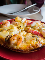 Still-life seafood pizza at italian restaurant.