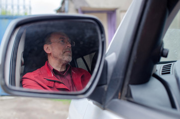 Aged man in the car