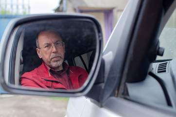 Aged man in the car