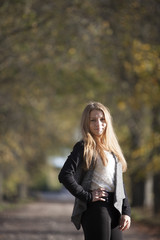Obraz premium Girl with a cute smile on sunny autumn day