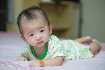 Asian baby on the bed