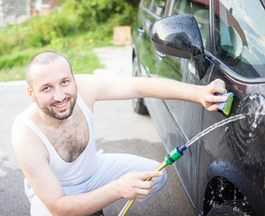 Young father and little sons washing ca