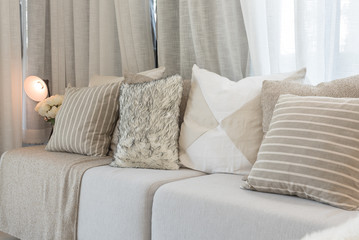 set of pillows on grey sofa in modern living room