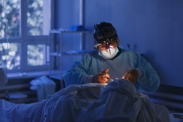 Real Surgeon working and holding surgical equipment