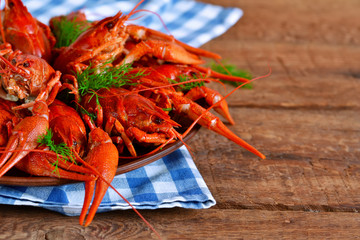 Fresh boiled crayfish with dill on a large plate