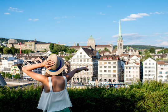 Young female tourist enjoying the beautiful old townscape view in Zurich city. Having a happy vacation in Switzerland