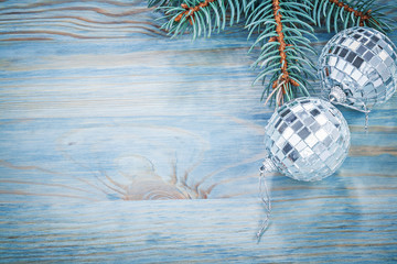 Christmas mirror baubles fir branch on wooden board copy space h