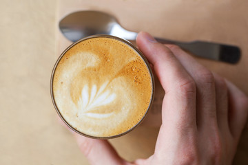 Cappuchino or latte coffe in a white cup with heart shaped foam
