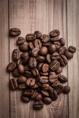 roasted coffee beans on wooden background, can be used as a background