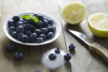 blueberries on rustic table / closeup portrait of blueberries on wood top