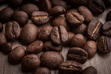roasted coffee beans on wooden background, can be used as a background