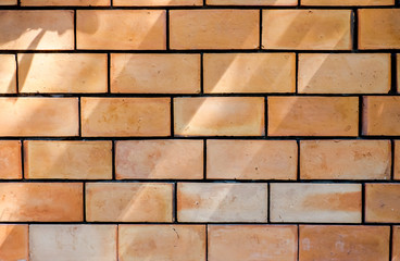 orange brick wall with shadow,outdoor house wall on sunny day