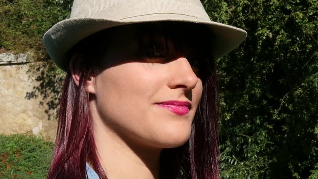 portrait of a pretty girl with a summer hat, slow motion