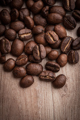 roasted coffee beans on wooden background, can be used as a background