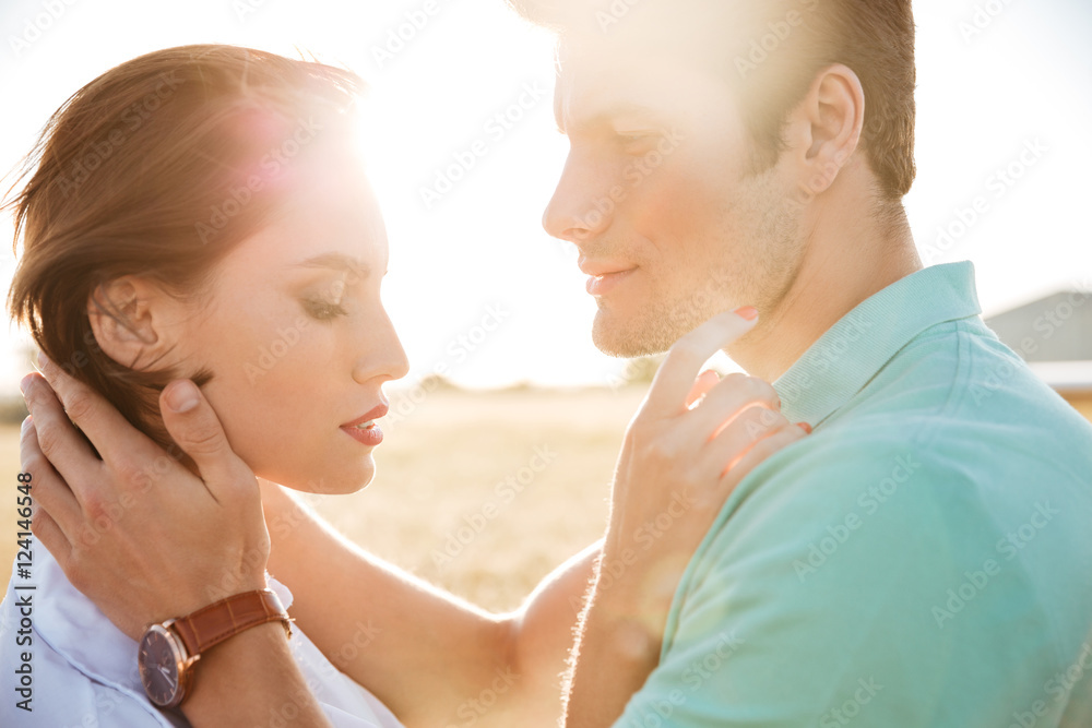 Canvas Prints Couple standing and huging outdoors on sunset