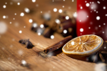 cinnamon, anise and dried orange on wooden board