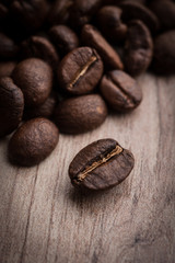 roasted coffee beans on wooden background, can be used as a background