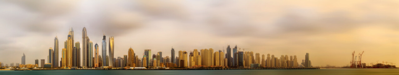 Panoramic view of Dubai Marina bay with cloudy sky, Dubai, UAE.