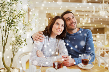 happy couple drinking tea at restaurant