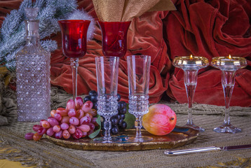 A luxury table in christmas decorations with glasses and fruit