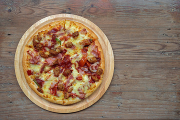 Pizza on a wooden tray.