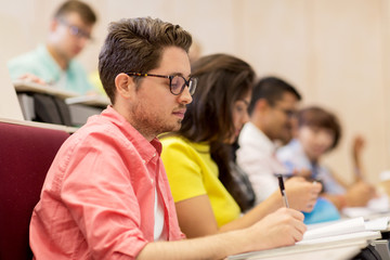 group of students with notebooks in lecture hall