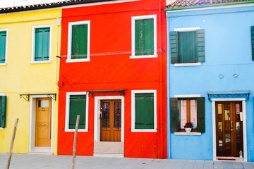 Obraz na płótnie Canvas traditional colored houses by a canal of Burano island in the venetian lagoon, Venice, Italy