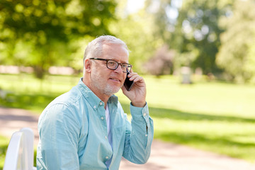 senior man calling on smartphone at summer park
